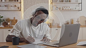 African student using laptop for studying at home