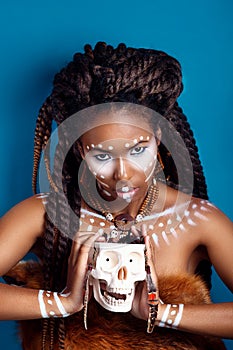 African style . Attractive young woman in ethnic jewelry . close up portrait of a woman with a painted face. Creative make up