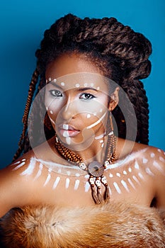 African style . Attractive young woman in ethnic jewelry . close up portrait of a woman with a painted face. Creative make up