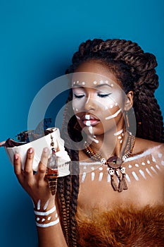 African style . Attractive young woman in ethnic jewelry . close up portrait of a woman with a painted face. Creative make up