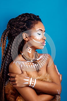 African style . Attractive young woman in ethnic jewelry . close up portrait of a woman with a painted face. Creative make up