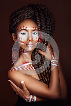 African style woman . Attractive young woman in ethnic jewelry. close up portrait. Portrait of a woman with a painted face.