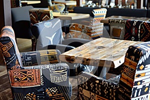 african textile upholstered chairs around a wooden table