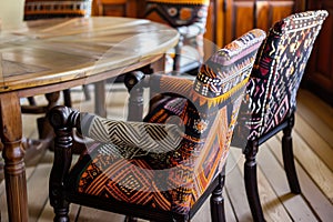 african textile upholstered chairs around a wooden table