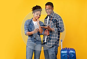 African Tourist Couple Using Smartphone Choosing Trip Destination, Studio Shot