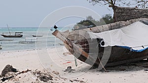 African Traditional Wooden Boat Stranded in Sand on Beach at Low Tide, Zanzibar