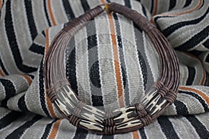 African tribal necklace with background made of African artifacts