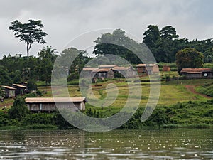 An African village is situated on the shores of the river Sangha (Republic of the Congo)