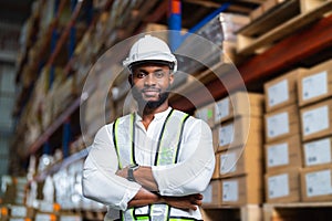 African warehouse manager standing in a large distribution center. concept of career and occupation