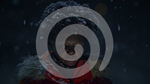 African Woman With Afro Hairstyle In Organge Clothes Outside in Strong Snowfall