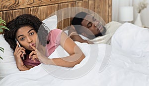 African woman cheating on her husband, talking with lover