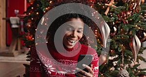 African woman on Christmas Eve receive great news on cellphone