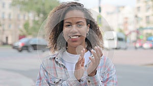 African Woman Clapping in Appreciation Outdoor