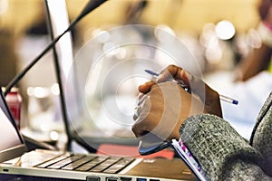 african woman at a convention holding her phone