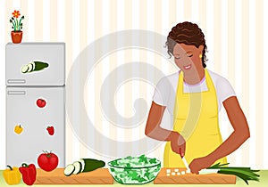 African woman cooking salad in the kitchen