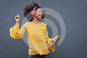 African woman dancing and listening music