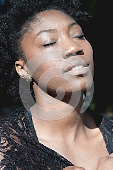 African Woman Daydreaming with Eyes Closed