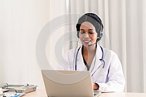 African woman doctor in headset taking calling on her headset