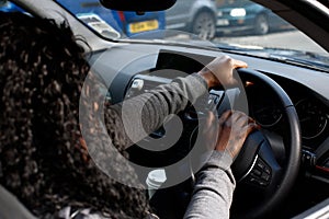 African woman driver honking her horn photo