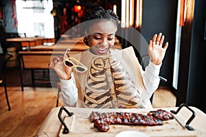 African woman eat spicy hot grilled spare ribs