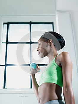 Žena cvičenie malé závažia v telocvičňa 