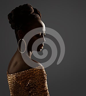 African Woman Face Profile Black Silhouette. Dark Skin Beauty Model with Gold Ring Earrings and Afro Braids Hairstyle in dress