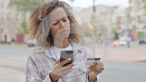 African Woman Frustrated by Online Shopping Failure Outdoor