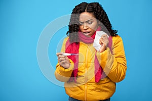 African Woman Having Fever Holding Thermometer Standing On Blue Background