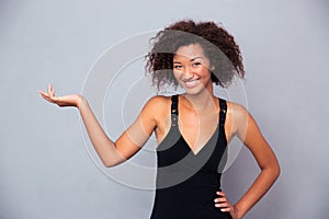 African woman holding copyspace on the palm