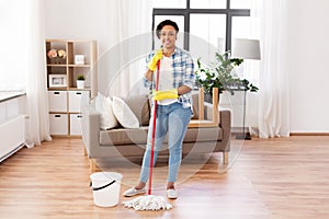 African woman or housewife cleaning floor at home