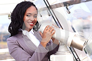 African woman looking through binoculars