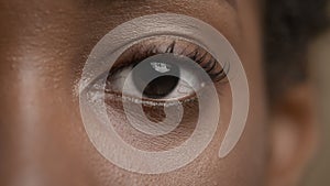 African Woman Looking At Camera On Beige Background, Eye Closeup