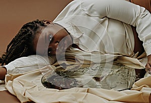 African woman lying in depression