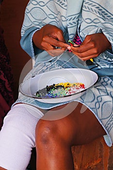 African woman making souvenirs for sell at Lesedi Cultural Villa