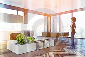 African woman in panoramic kitchen and living room