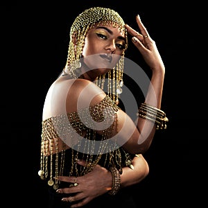 African woman, portrait and gold fashion with beauty and cosmetics in a studio. Isolated, black background and young