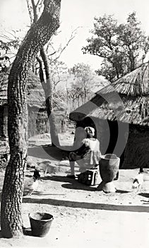 An African woman preparing food in a rural village near Damongo in Ghana, c.1959