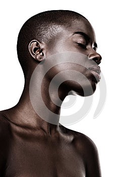 African, woman and profile of beauty with skincare in studio on white background with glow on skin from dermatology