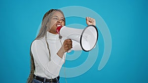 African woman protesting while shouting with a loudspeaker