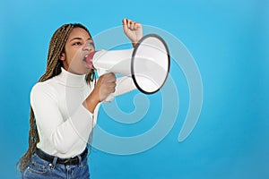 African woman protesting while shouting with a loudspeaker