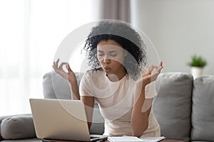 African woman reducing stress do yoga exercise to calm down