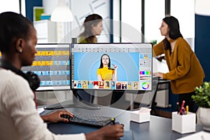 African woman retoucher sitting in modern creative photo studio