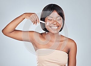 African woman, rose quartz roller and studio with smile for skin routine with natural glow by background. Girl, person