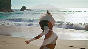 African woman running sandy beach summer day. Girl jogging on Ursa seashore.