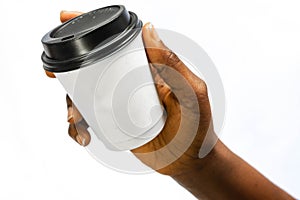 African Woman`s hands holding white paper coffee cup or another hot drink in the cold season on white. Creative Mockup of