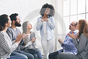 African woman sharing her achievement with rehab group