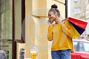 African woman shopping and talking on cellphone