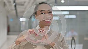 African Woman showing Heart Shape by Hands