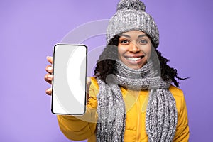 African Woman Showing Smartphone Empty Screen Over Purple Background