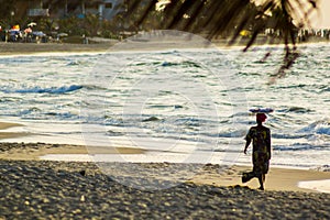 An african woman silhouetted on the beach